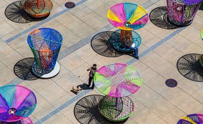 Overhead view of art exhibition consisting of spinning tops